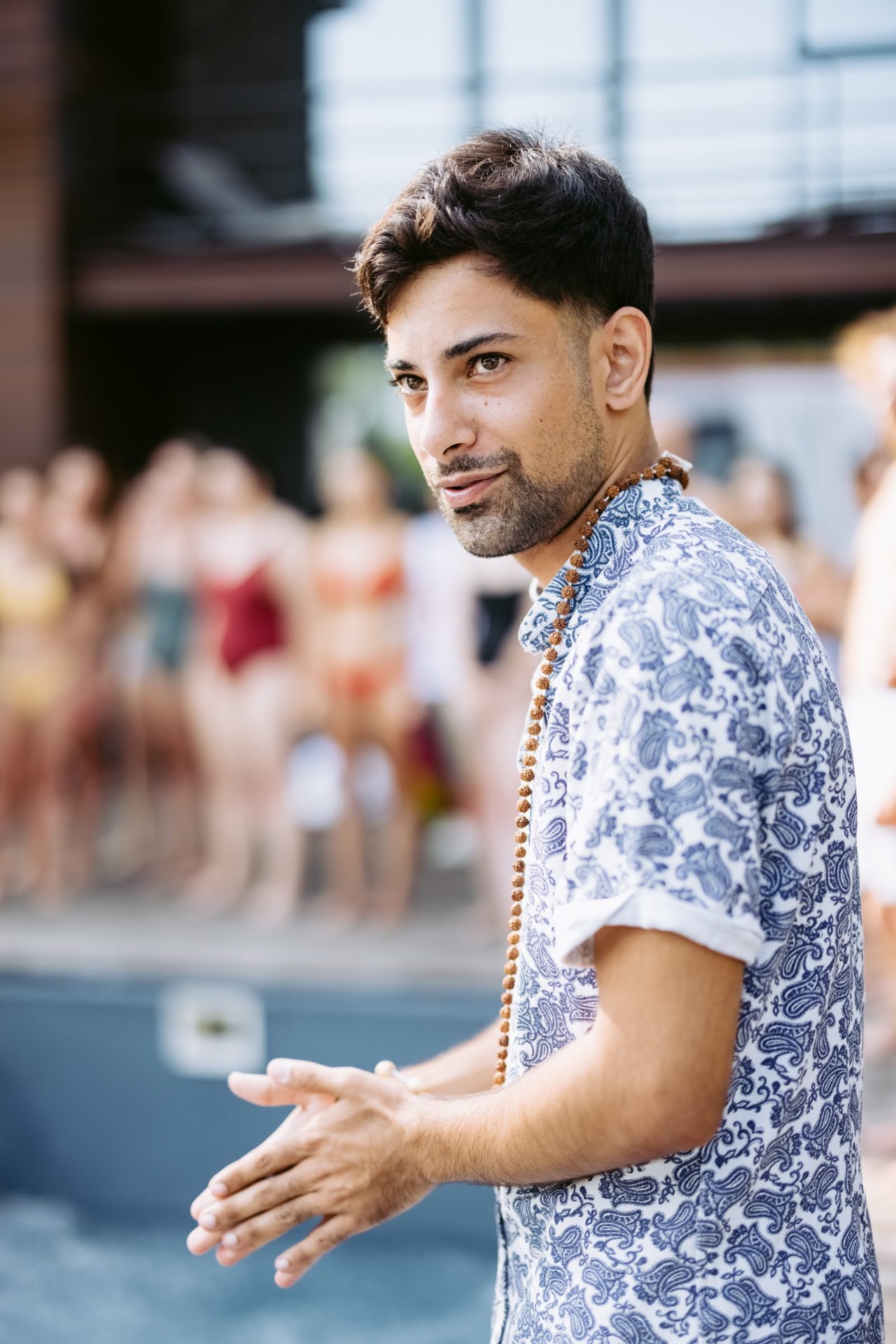 Victor Goenka leading a BreathX Collective community gathering at a poolside breathwork retreat